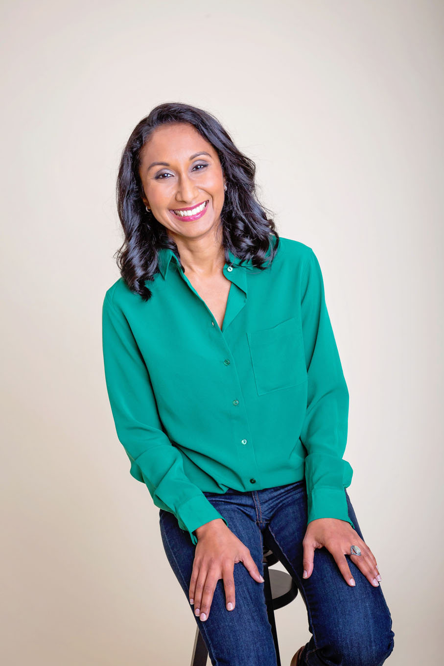 A portrait of a woman taken in a studio set up with backdrop and lighting equipment